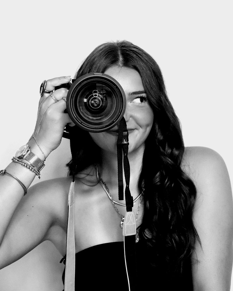 Hayden looking past her camera lens